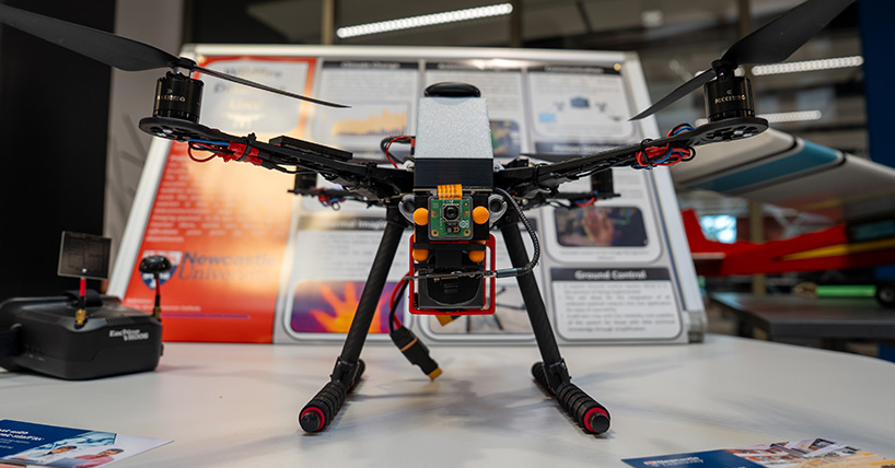 Drone resting on table while being preppred by Aerospace Engineering students Drone resting on table while being preppred by Aerospace Engineering students