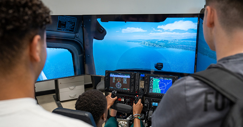 Students learning to fly a simulator plane Students learning to fly a simulator plane