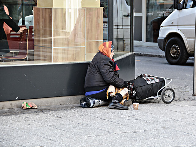 Article 22: Homeless woman on city street.