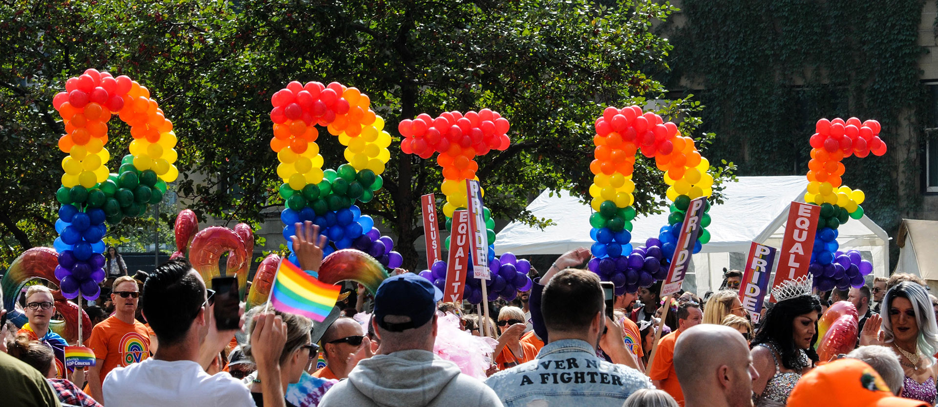 A Pride march; balloon sculptures spelling out ’PRIDE’.