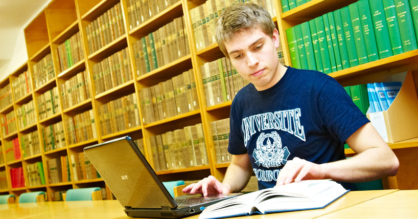 Postgraduate student studying in the Law library