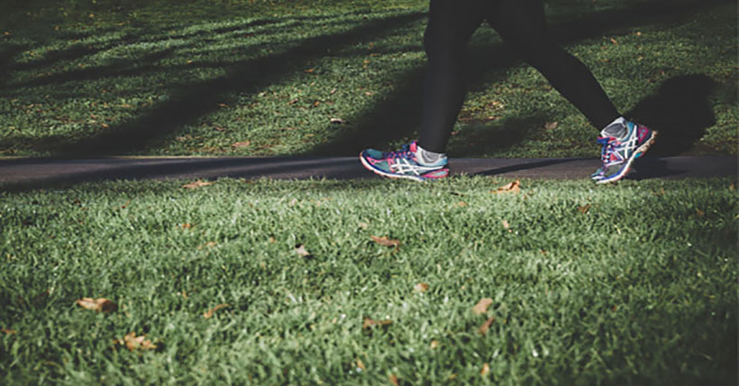 Close up of person walking in trainers.