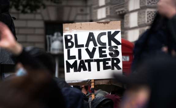 A protester holding a placard reading "Black Lives Matter"