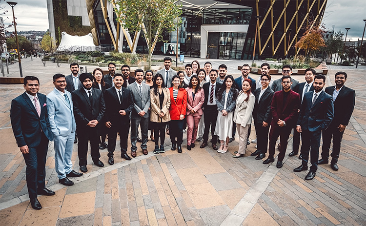 The 2025 MBA cohort standing on the Helix in front of the Catalyst building