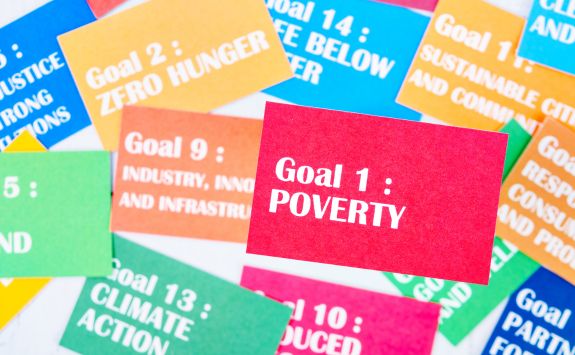 A collection of colourful cards featuring various sustainable development goals, including "Goal 1: Poverty" in bold.