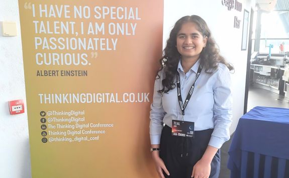 Tejal Jain at the Thinking Digital Conference 2024, standing next to a banner with an Albert Einstein quote: 