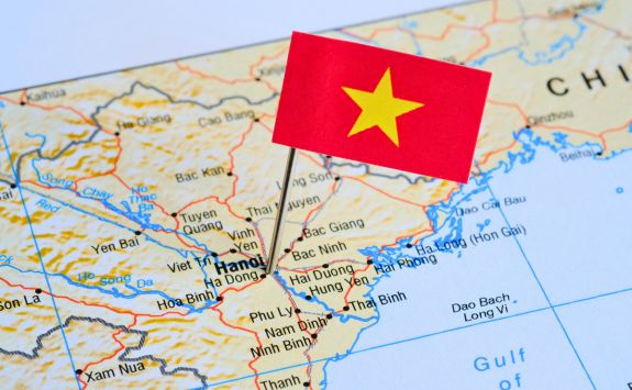 A map of Vietnam with a small red flag pinned on Hanoi, highlighting the location.