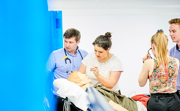 Medical students practising on a Manikin 