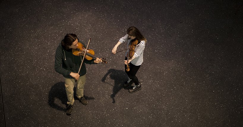 Two violinists pictured from above