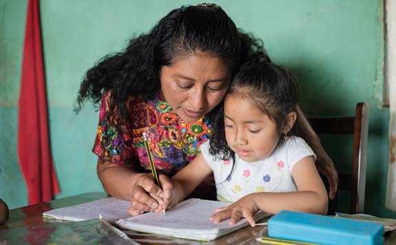 Mother helping daughter to do her homework